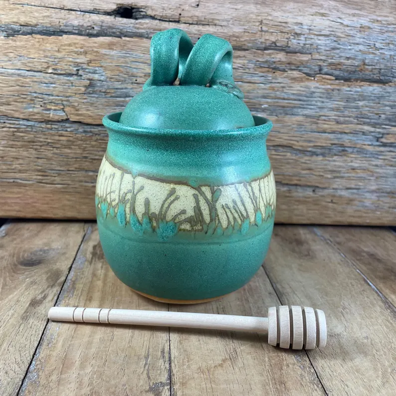Copper green honey jar with grass texture and honey dipper