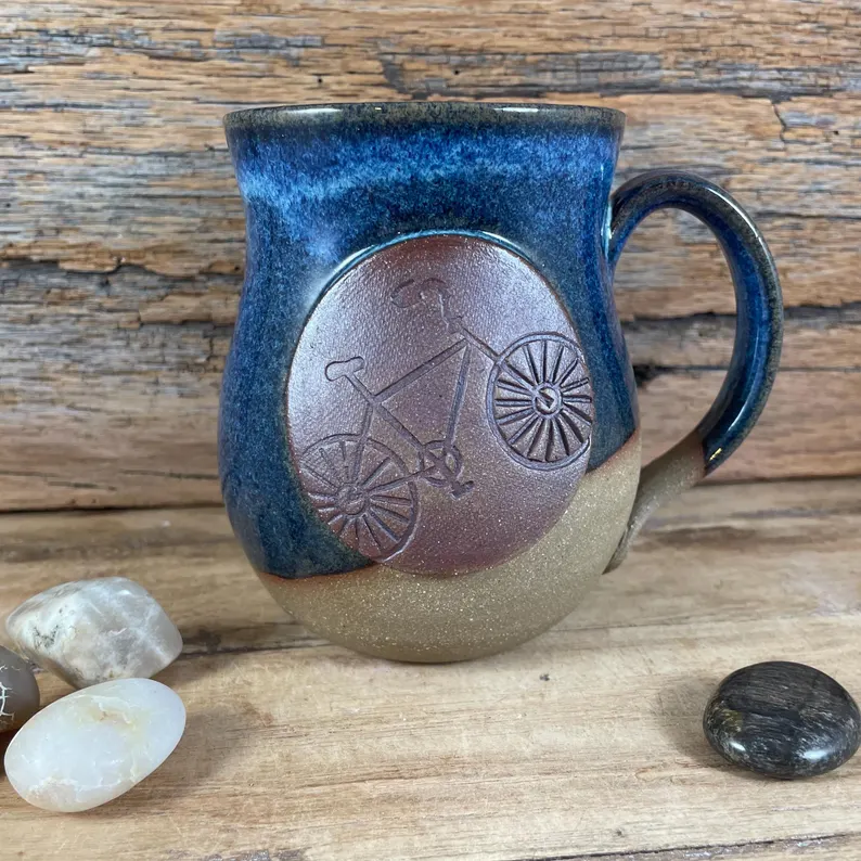Handcrafted ceramic mug with bicycle medallion